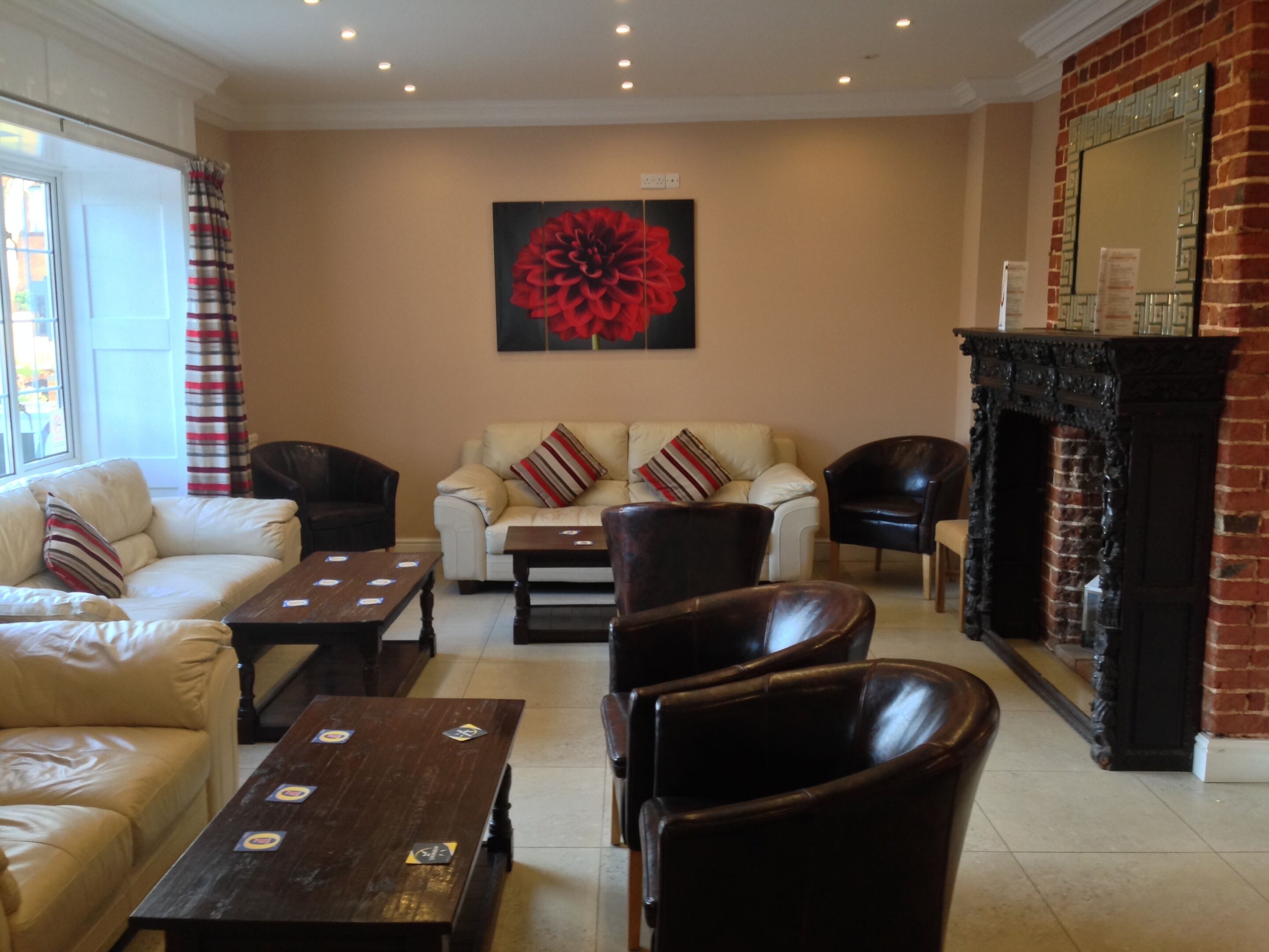 A living room with a fireplace, a sofa, armchairs, and a coffee table.