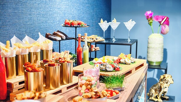 A buffet with various food items and drinks, including sushi, salads, and desserts. - NYX Hotel Mannheim by Leonardo Hotels (Mannheim)