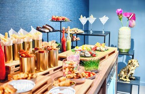A buffet with various food items and drinks, including sushi, salads, and desserts. - NYX Hotel Mannheim by Leonardo Hotels (Mannheim)