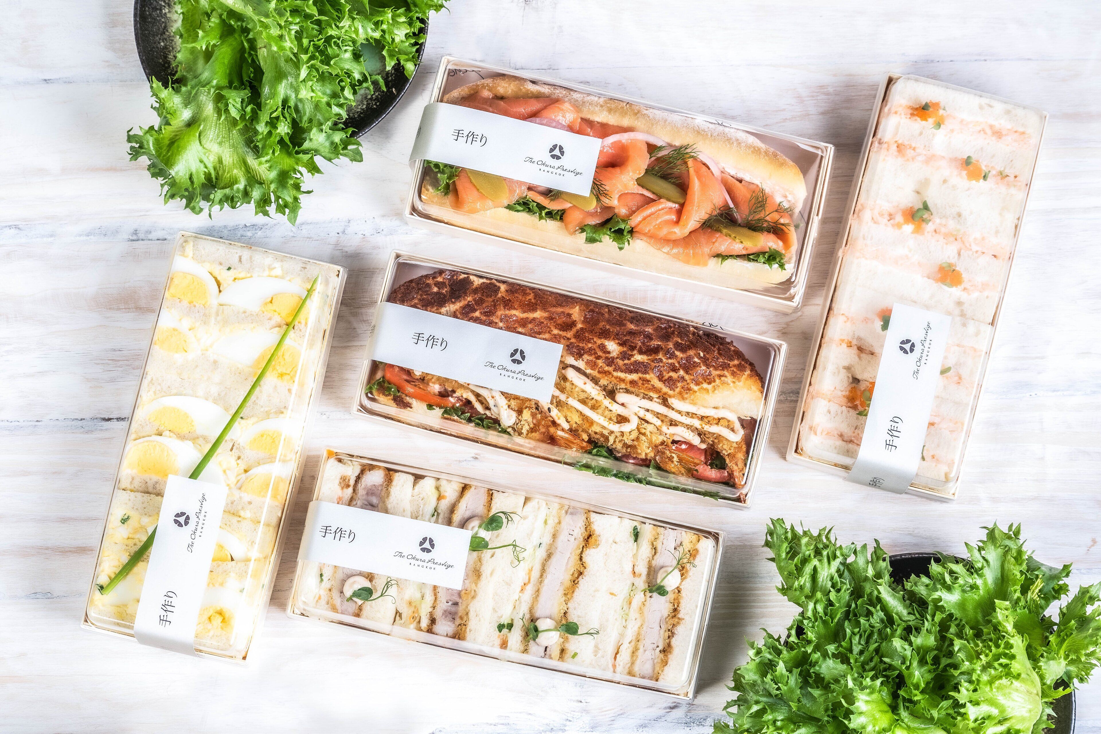 Une variété d’aliments présentés dans des récipients transparents, chacun étant muni d’une étiquette, et disposés sur une surface blanche.