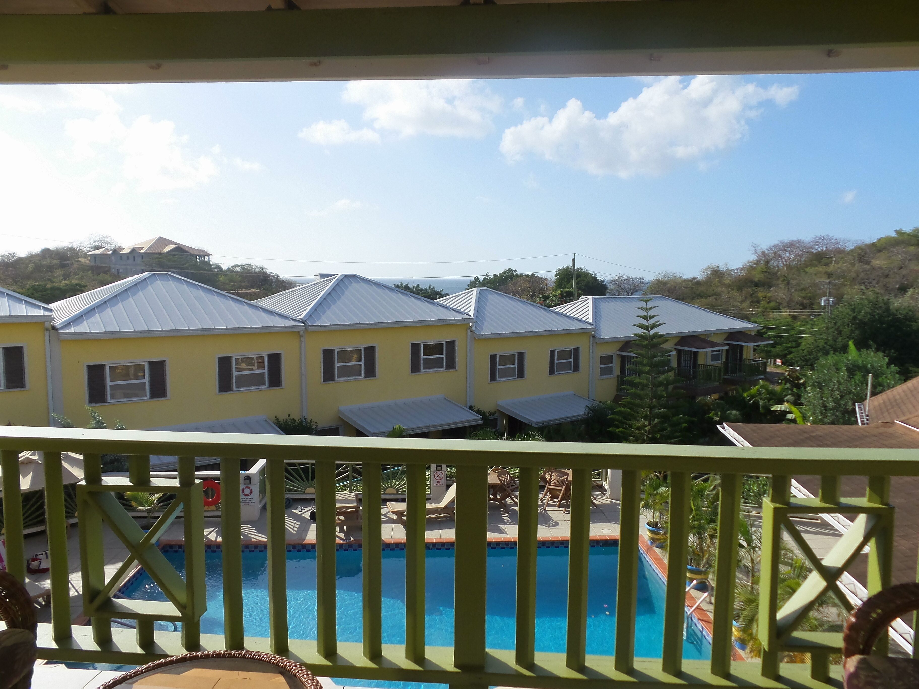 A pool area with a view of yellow buildings in the background.