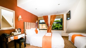 A hotel room with a bed, a desk, a chair, a telephone, and a window with curtains. - Newcastle Jesmond Hotel (Newcastle-upon-Tyne)