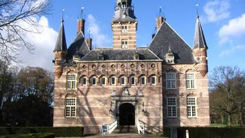 A historic building with a central entrance, multiple towers, and a symmetrical facade.