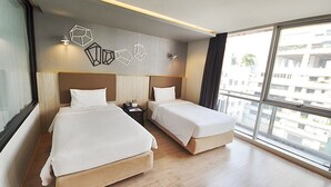 A modern hotel room with two beds, a large window, and geometric wall art. - The Heritage Hotels Bangkok (Bangkok)