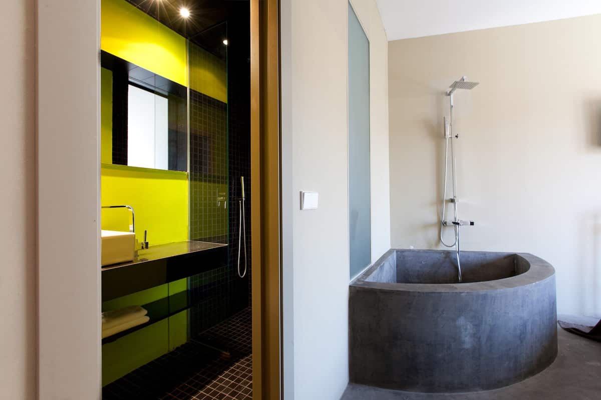 A modern bathroom with a large, round bathtub and a separate shower area.
