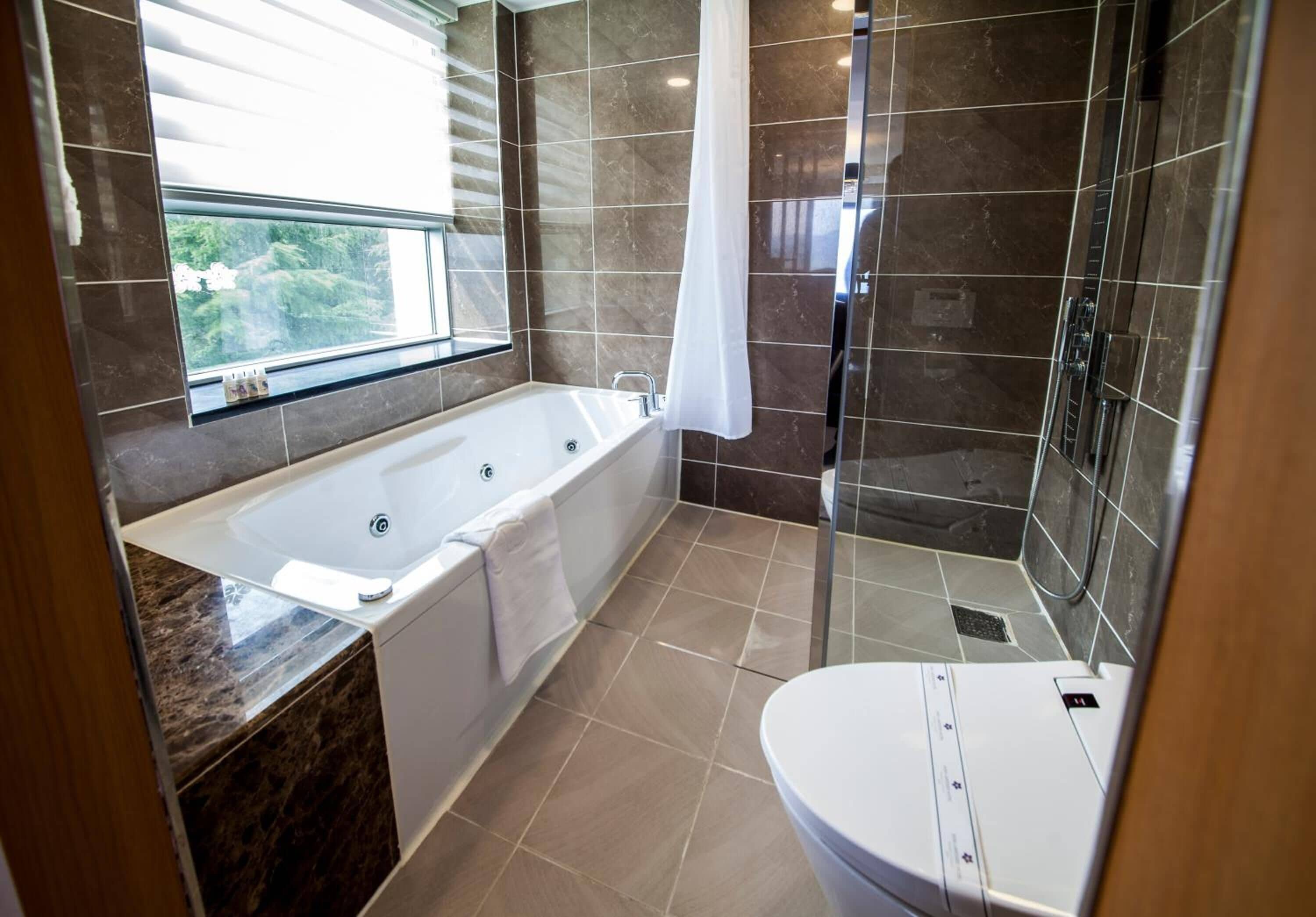 combined shower/bathtub, deep-soaking bathtub, designer toiletries