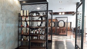 A modern interior with a wine display and a traditional decorative screen. - Hotel Geumosan (Gumi)