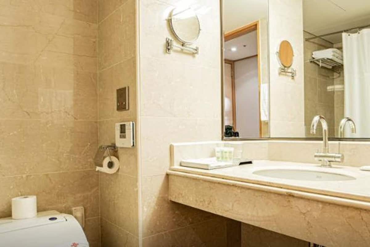 superior single room | bathroom | bathtub, free toiletries, hair dryer, bathrobes