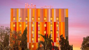 A hotel building with a striped facade and the name 'ibis Hotel' at the top. - ibis Navi Mumbai Hotel (Navi Mumbai)