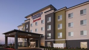 A Fairfield Inn & Suites by Marriott hotel with a modern design, featuring a covered entrance and multiple floors.