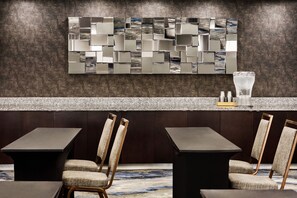 A modern bar area with a textured wall, a mosaic artwork, and a granite countertop. - Fairfield Inn & Suites Amarillo Airport (Amarillo)