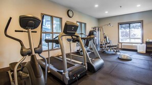 A gym with treadmills, elliptical machines, and a wall clock. - Comfort Inn & Suites (Fort Saskatchewan)
