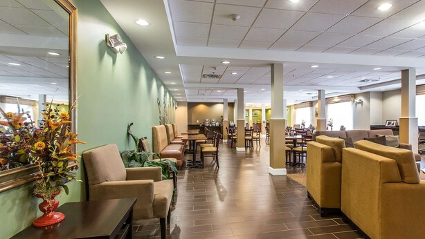 A hotel lobby with seating areas, a reception desk, and a coffee bar. - Sleep Inn & Suites Mount Olive North (Mount Olive)