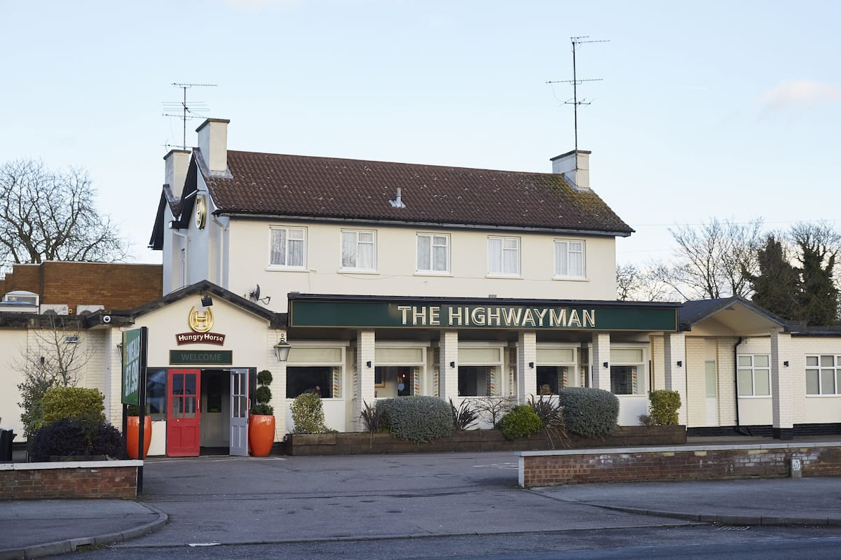 A two-story building with a sign reading "The Highwayman."