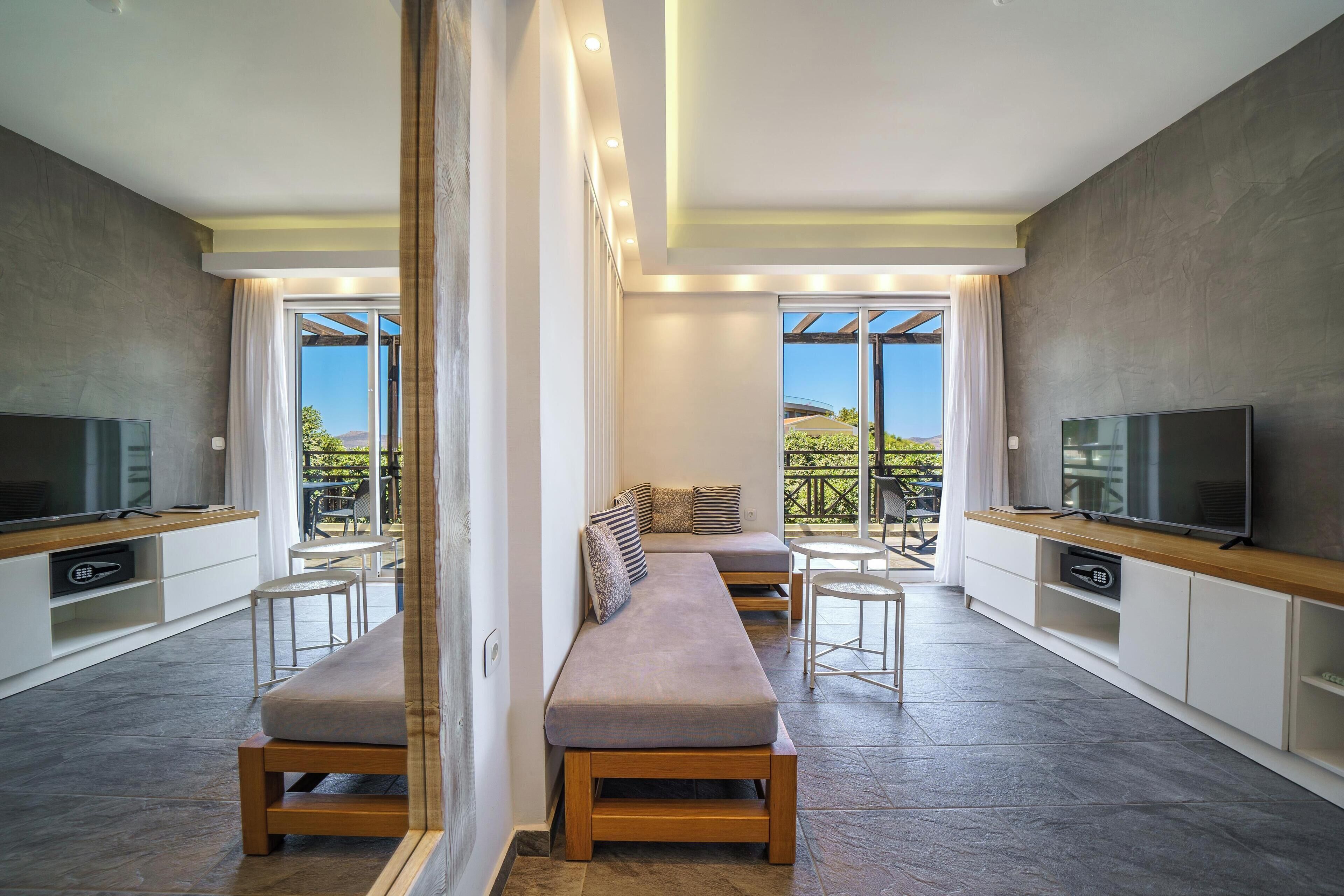 deluxe suite, hot tub, sea view | living area | 14-inch flat-screen tv with digital channels, tv