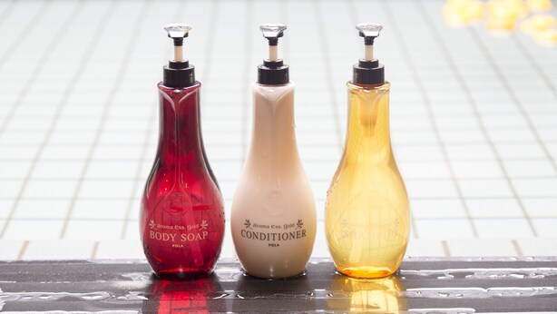Three bottles of body soap, conditioner, and shampoo on a tiled surface. - Dormy Inn Premium Shibuya Jingumae Hot Spring (Tokyo)