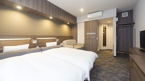 A modern hotel room with a large bed, a seating area, a television, and an air conditioning unit. - Dormy Inn Premium Shibuya Jingumae Hot Spring (Tokyo)