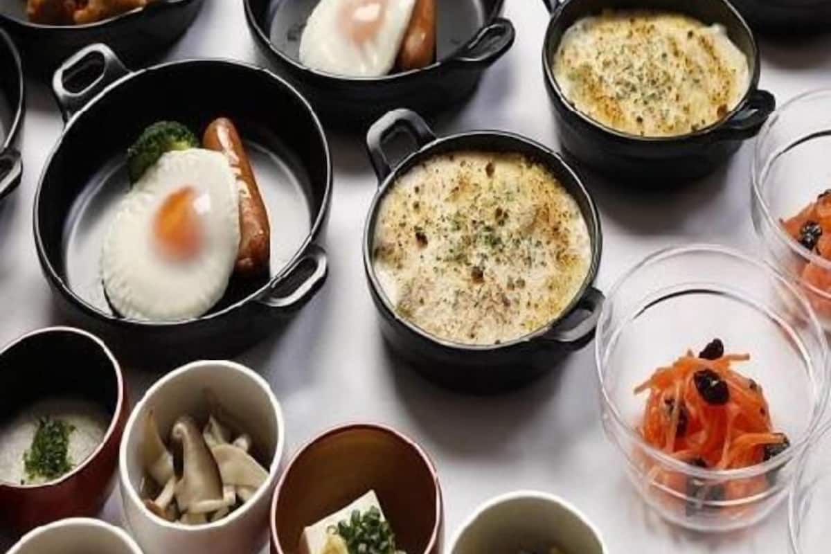A variety of dishes served in black bowls on a table.