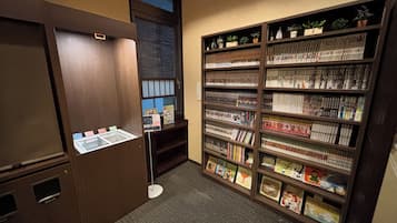 A library with bookshelves, a display case, and a door.