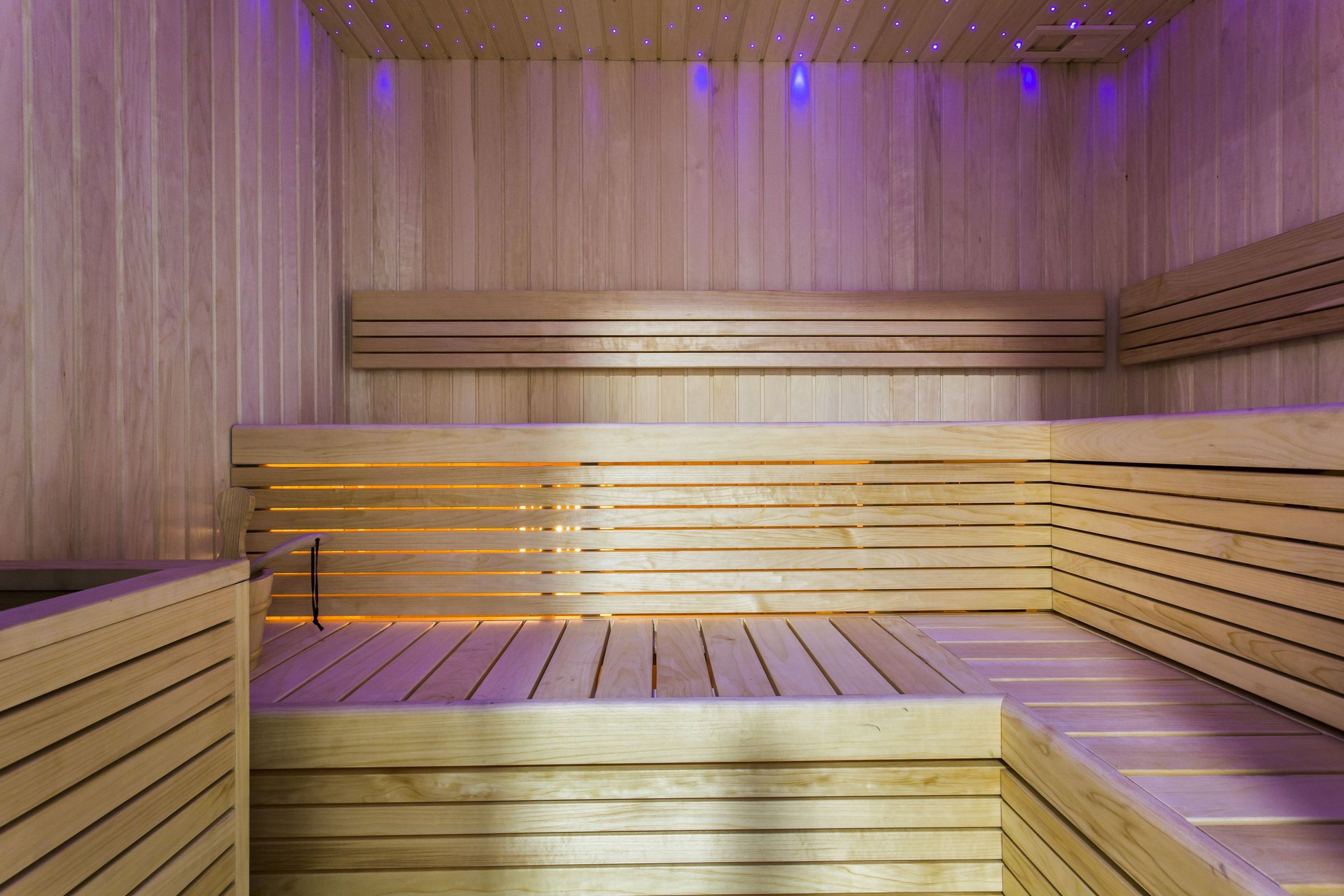 A sauna with wooden benches and slatted walls.