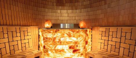 A sauna with a brick wall and wooden benches.