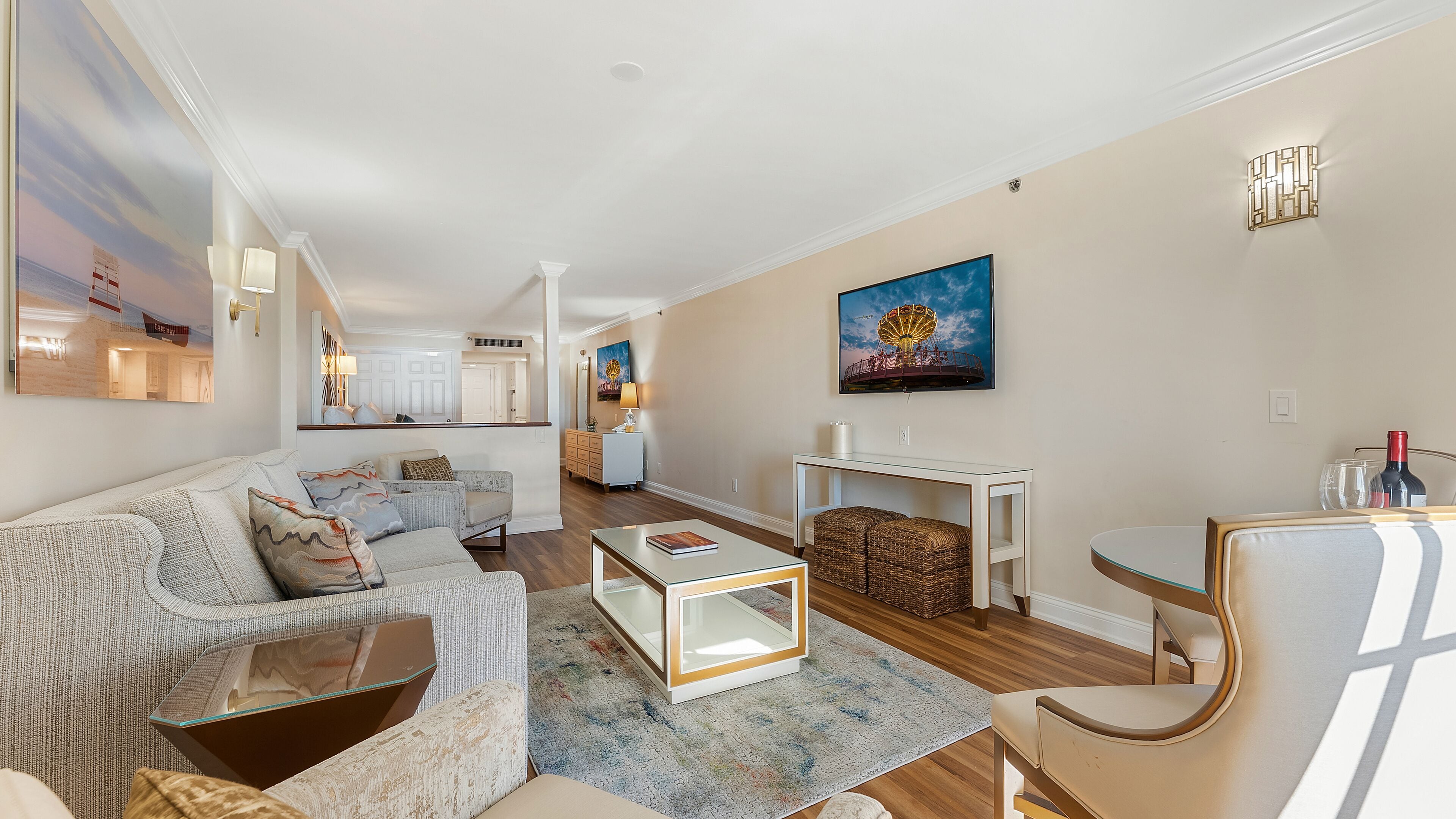 A spacious living room with a sofa, coffee table, and a dining area with a table and chairs.
