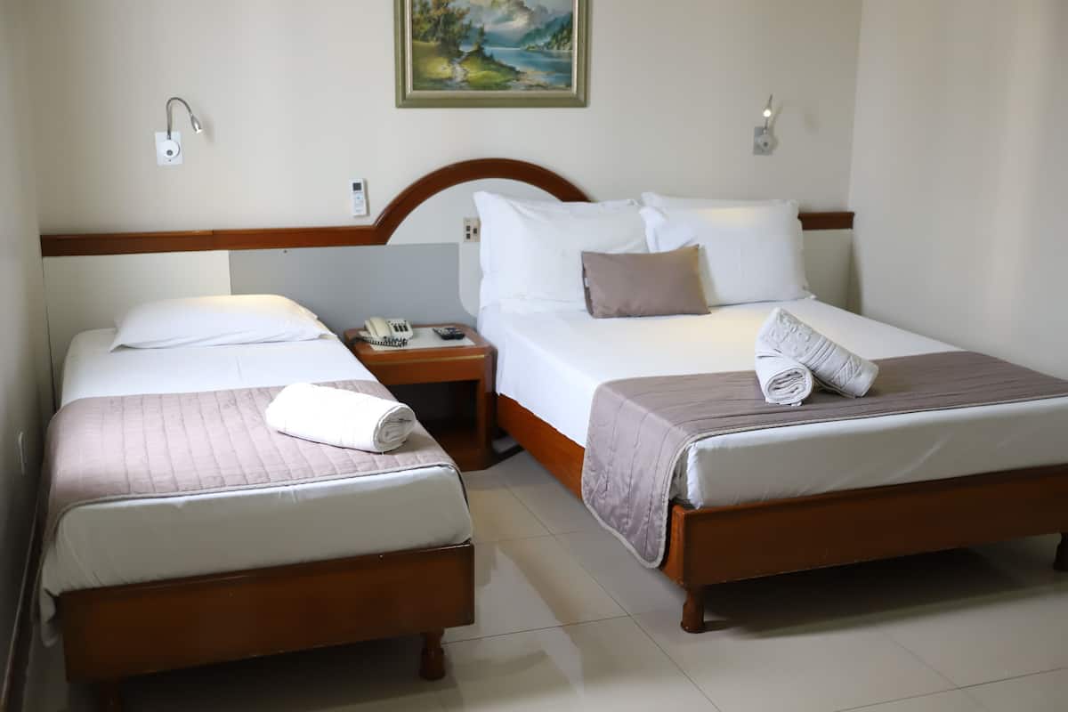 Deluxe Triple Room, Multiple Bedrooms | Minibar, desk, blackout drapes, travel crib
