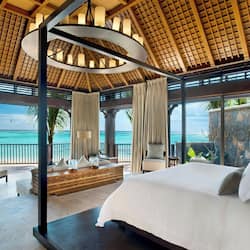 On the beach, white sand, sun loungers, beach umbrellas