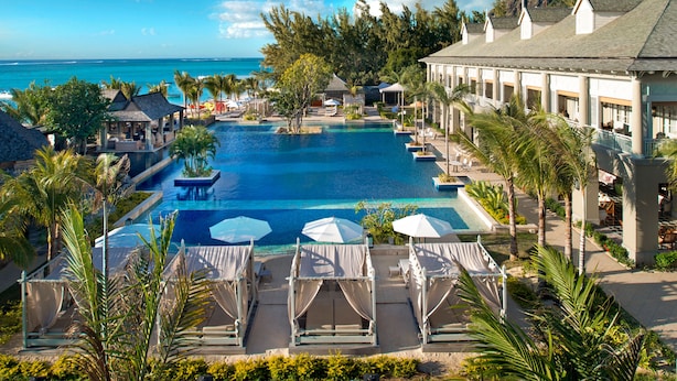 A resort with a large infinity pool, lounge areas, and a view of the ocean. - The St. Regis Le Morne Resort, Mauritius (Le Morne)