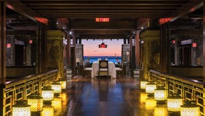 A restaurant with a view of the sea, wooden flooring, and lantern-style lighting. - The St. Regis Le Morne Resort, Mauritius (Le Morne)
