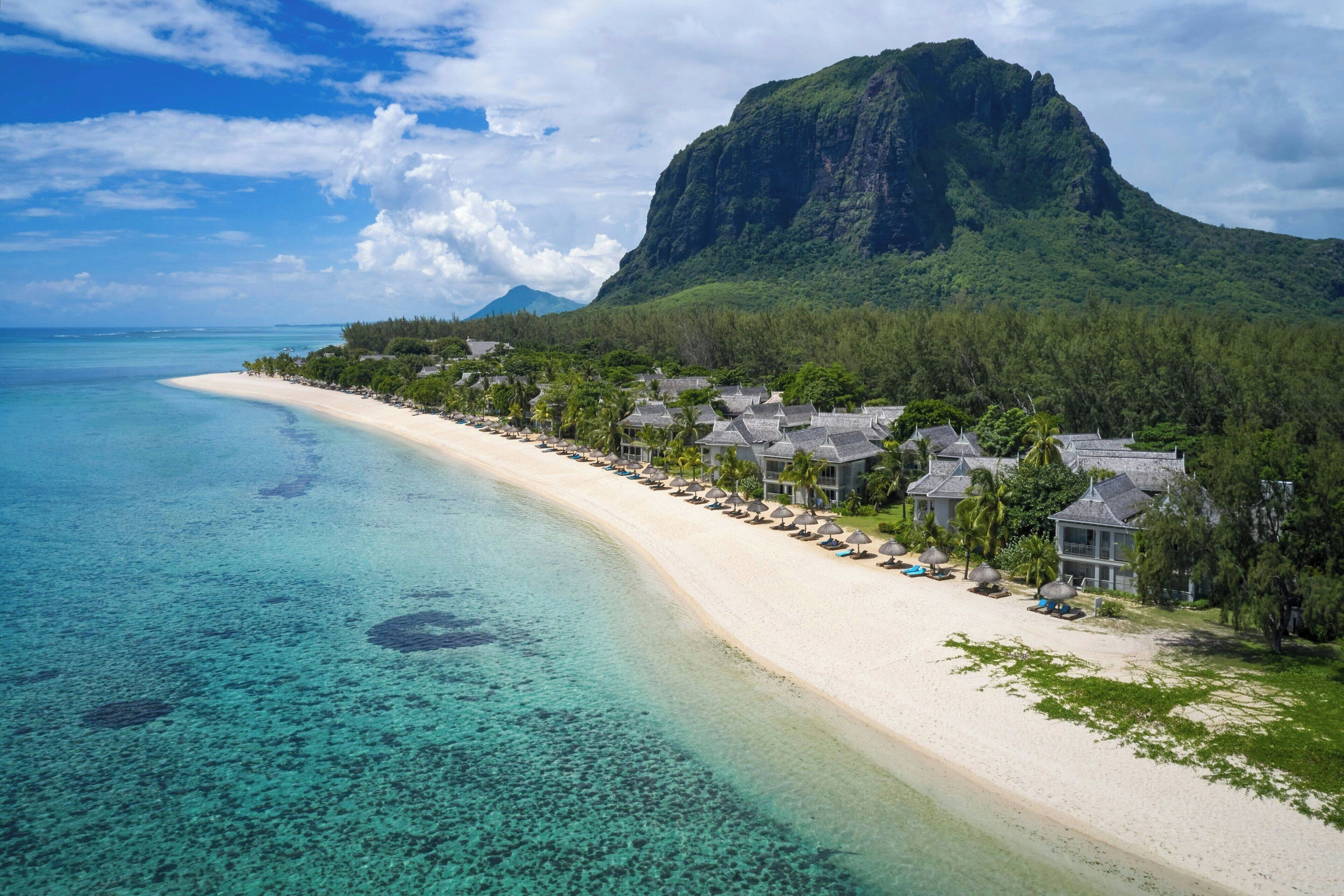 On the beach, white sand, sun loungers, beach umbrellas