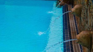 A swimming pool with clear blue water and a tiled edge. - Asian Mansion Il (Makati)