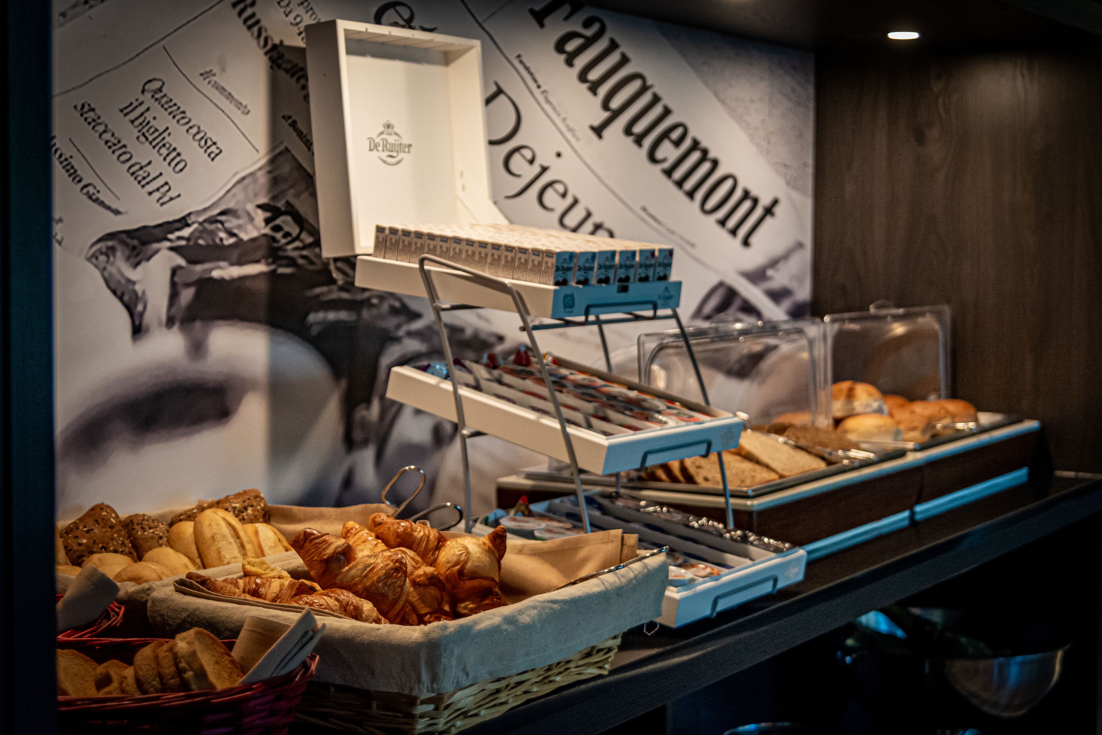 A buffet with various baked goods and a De Ruiter coffee machine.