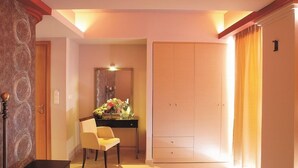 Quarto com escrivaninha, cadeira e guarda-roupa.