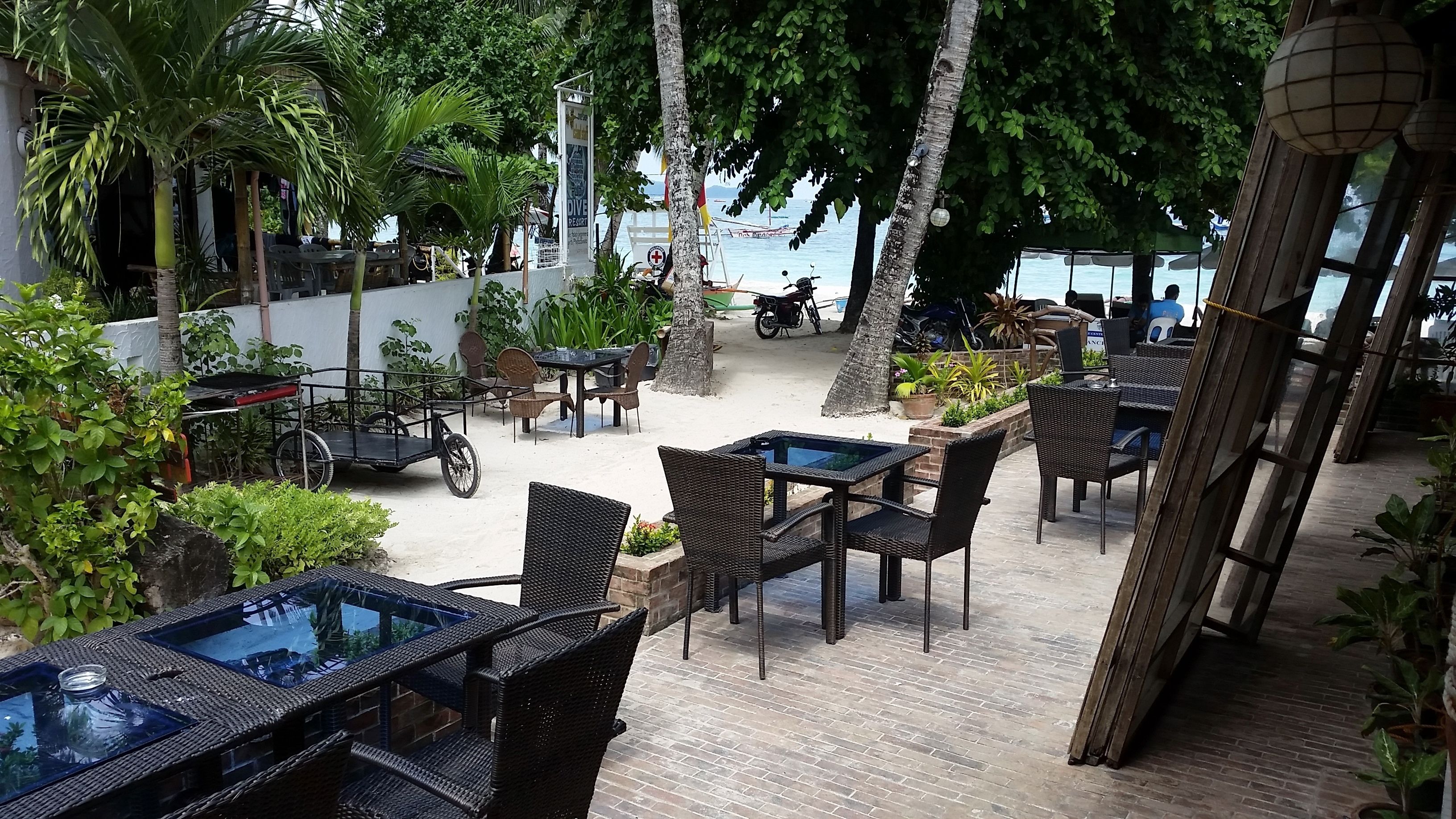 An outdoor seating area with wicker furniture and a water feature.