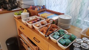 A breakfast buffet with various food items and beverages. - Alexandra Hotel (Weymouth)