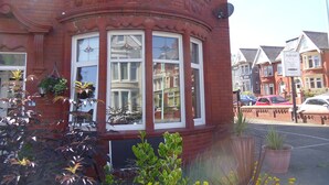 A corner building with a bay window, brick facade, and a signboard. - The Beaucliffe (Blackpool)