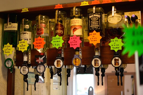 A bar with various liquor bottles and price tags.