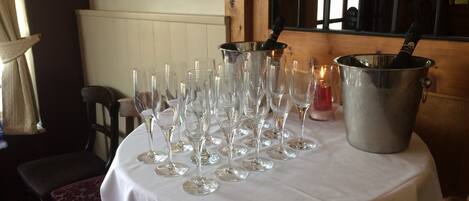 A table with multiple wine glasses and a bucket, likely for a special event or celebration.