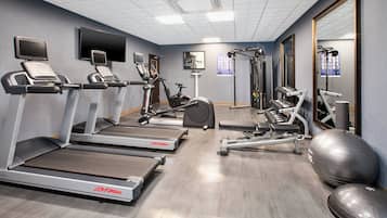 A gym with treadmills, stationary bikes, and weight machines.