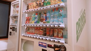 A beverage vending machine stocked with various drinks. - Smile Hotel Namba (Osaka)