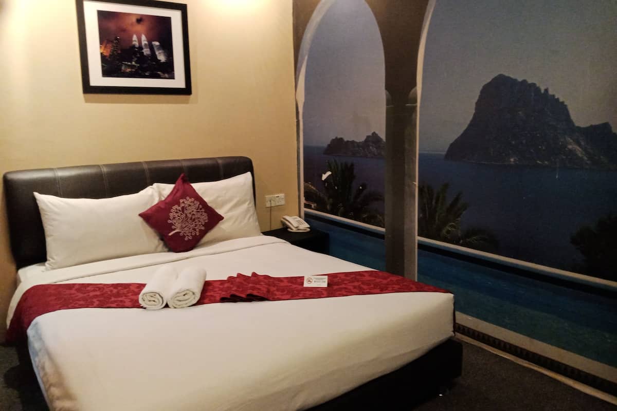 A hotel room with a bed, a nightstand, a phone, and a view of the ocean.