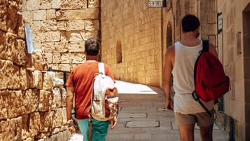 A narrow stone corridor with a sign for the Cathedral Museum.