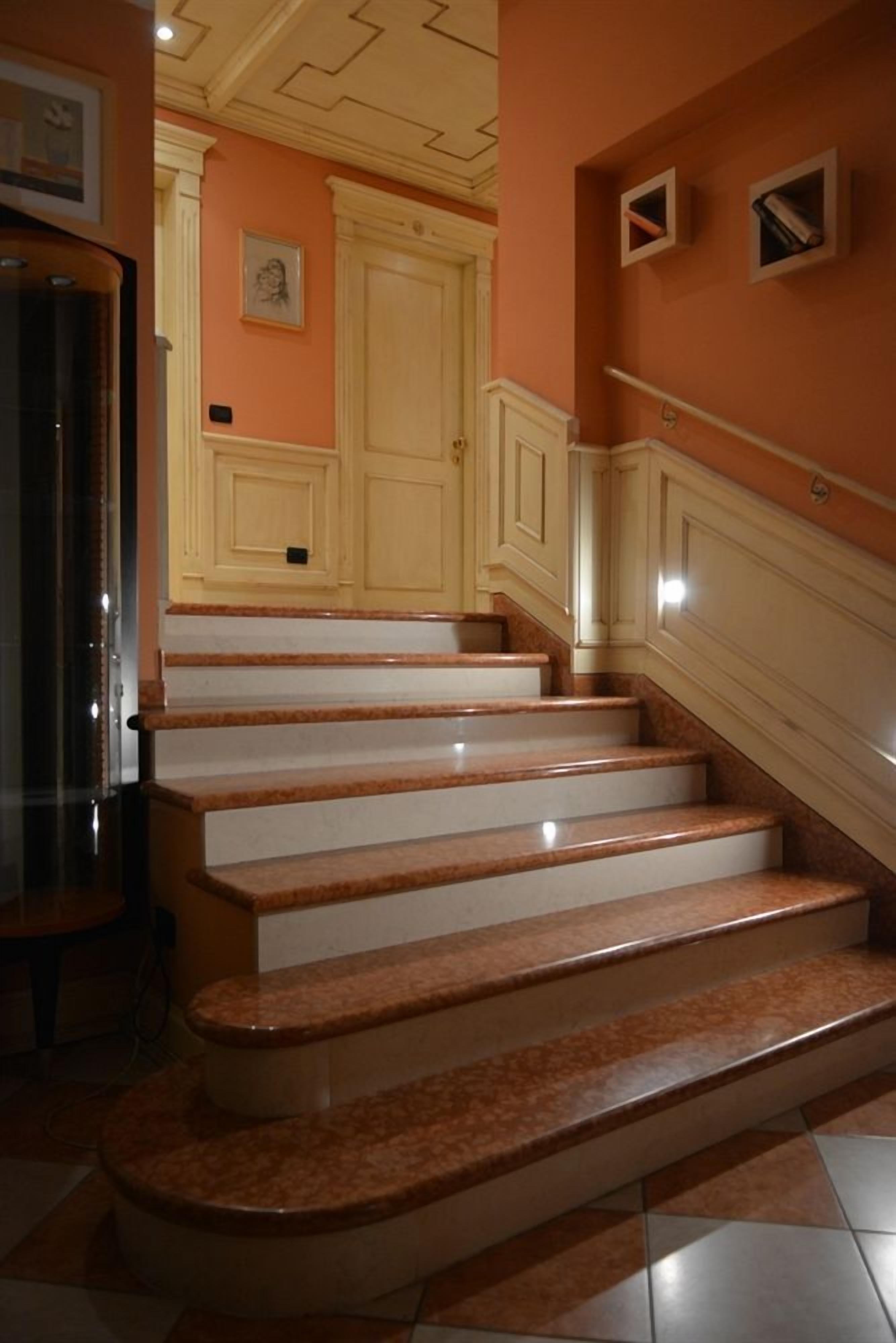 A staircase with marble steps leading to a door.