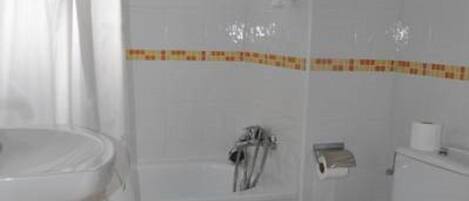 A bathroom with a white sink, toilet, and bathtub.