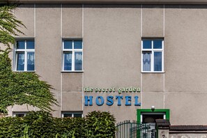 A building with a sign reading "The Secret Garden HOSTEL."