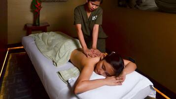 Experience soothing massages in a serene space with a massage table and expert therapist.
