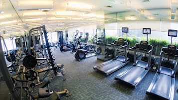A gym with treadmills, weight machines, and exercise equipment.