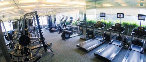 A gym with treadmills, weight machines, and exercise equipment.