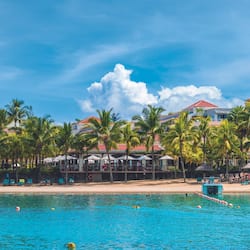On the beach, white sand, sun-loungers, beach towels